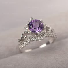 * The delicate ring displays amethyst as main stone. The curved band beneath the gemstone makes the ring like an elegant crown. For who wearing this dainty ring, will shine like a queen. ◆ Production Description: Main stone Type: Amethyst Main Stone Shape: Round Cut Main Stone Size: 7*7mm Side stone: CZ Metal: 925 Sterling silver - Other options available in the drop down menu ◆ Customization: √Free for Add Engraving √Other Metal Type Available √Other Gemstones & Shapes Available √Personaliz Luxury Amethyst Ring With Accent Stones For Promise, Elegant Lavender Amethyst Ring Luxury, Elegant Amethyst Wedding Ring, Elegant Wedding Amethyst Ring, Elegant Amethyst Crystal Ring With Center Stone, Elegant Amethyst Rings For Wedding, Elegant Amethyst Diamond Promise Ring, Elegant Amethyst Crystal Ring With Accent Stones, Fine Jewelry Amethyst Stackable Wedding Rings