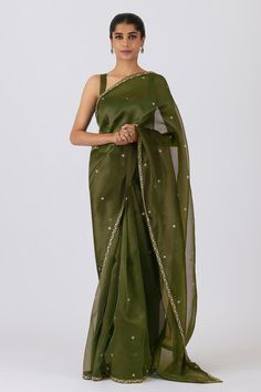 Olive green saree with hand-embroidered tiny all-over motifs and a light gold floral border incorporating flowers, leaves, and vines. Comes with blouse. Components: 2 Pattern: Embroidered Type Of Work: floral Neckline: Sweetheart Sleeve Type: Sleeveless Fabric: Silk Organza Color: Green Other Details:  Embroidered border Occasion: Puja - Aza Fashions Green Sari, Simple Saree Designs, Traditional Indian Dress, Simple Sarees, Indian Fashion Saree, Saree Designs Party Wear, Embroidered Border