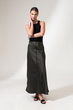 The Alicia Skirt is a flared fit, floor length skirt, crafted from a fine satin. This fluid skirt has an A-Line shape, an easy pull-on style, and an effortlessly elevated finish with French seams and visible front hem detail. This sustainable skirt is tailor made and on demand. It takes us 3 hours to make this skirt. PLEASE ALLOW 1-5 BUSINESS DAYS FOR PRODUCTION Sleek Flared Maxi Skirt For Evening, Sleek Long Maxi Skirt For Spring, Sleek Relaxed Maxi Skirt, Sleek Long Lined Skirt, Flowy Wide Leg Skirt With Bias Cut, Sleek Flowy Long Skirt, Sleek Long Flowy Skirt, Sleek Long Bias Cut Skirt, Sleek Satin Maxi Skirt With Lining