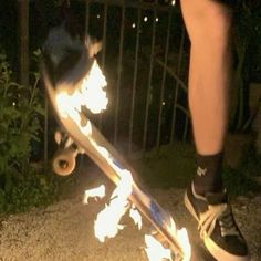 a person on a skateboard with flames coming out of the bottom part of it