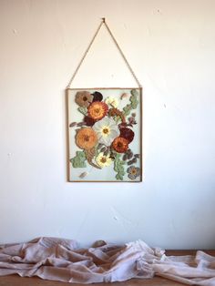 a painting hanging on the wall above a bed