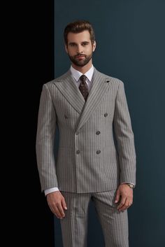 This ash and charcoal pinstripe suit for men or women is an nice addition to office wear or professional events. With the elegance of the grey stitching, this suit will pair well with many color varieties making it a suit that can be worn in any season and any setting. Like this look, but want to make some changes? Chat with a stylist or book an appointment. FREE SHIPPING ON ORDERS OVER $199 COLOR Grey COMPOSITION 100% Wool YARN COUNT Super 120s WEIGHT 290g FABRIC STYLE Pinstripe OCCASION Busine Elegant Gray Double Breasted Suit For Semi-formal Occasions, Gray Double Breasted Suit For Office, Gray Double-breasted Suit For Office, Classic Gray Double Breasted Suit For Office, Pinstripe Double Breasted Business Casual Suit, Pinstripe Double Breasted Suit For Business Casual, Elegant Striped Double-breasted Suit For Office, Striped Tuxedo Suit For Business, Gray Double Breasted Suit For Work