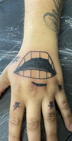 a person's hand with a tattoo on it