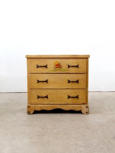 a wooden dresser with four drawers on it