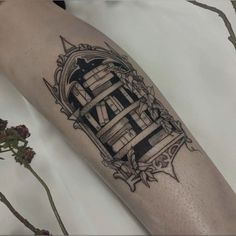 a black and white photo of a person's arm with a tattoo on it