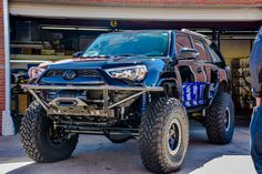 a monster truck parked in front of a building