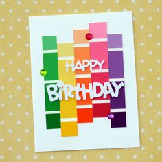 a card with the words happy birthday written on it and colorful strips of colored paper