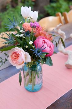 a vase filled with pink flowers on top of a table