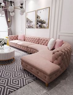 a living room filled with pink couches and white tables in front of large windows