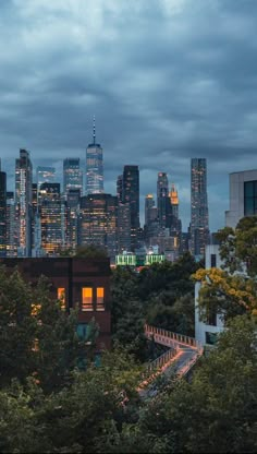 the city skyline is lit up at night, with skyscrapers visible in the distance