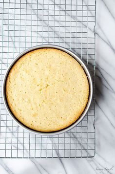 a cake in a pan on a cooling rack