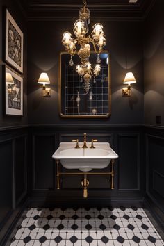 a bathroom with black and white tile flooring and chandelier above the sink