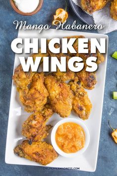 chicken wings on a plate with dipping sauce