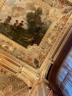 an ornate painting on the ceiling of a building