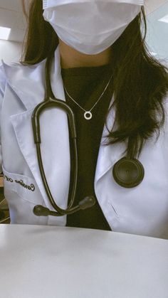 a woman wearing a white lab coat with a stethoscope on her neck