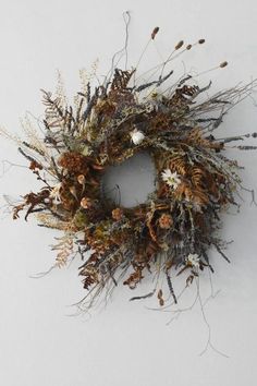 a dried wreath is hanging on the wall