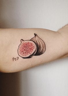 a tattoo on the arm of a person with a piece of fruit