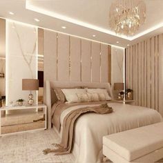 a bedroom with a large bed and chandelier