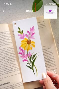 an open book with watercolor flowers on it