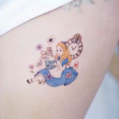 a tattoo on the side of a woman's thigh with an image of alice