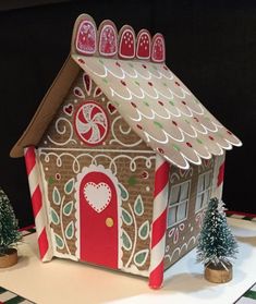 a gingerbread house is decorated with candy canes