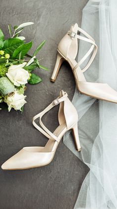 the bride's shoes and bouquet are on the table