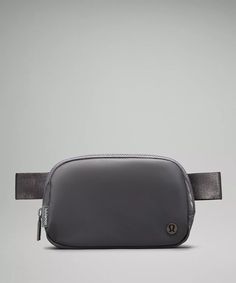 a gray belt bag sitting on top of a table