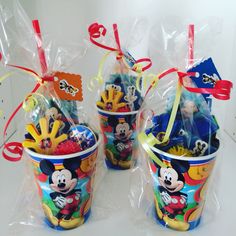 three plastic buckets filled with mickey mouse toys