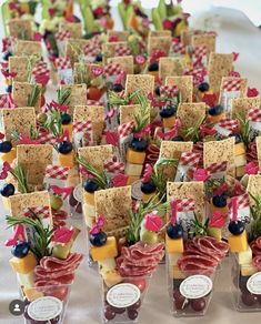 a table topped with lots of different types of snacks and crackers on top of each other