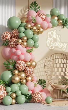 the balloon arch is decorated with giraffes, balloons and greenery in pastel colors