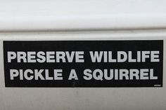 a sticker on the side of a white car that says preserve wildlife pickle a squirrel