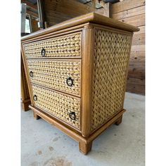 an old wicker dresser with black knobs on it's handles and drawers