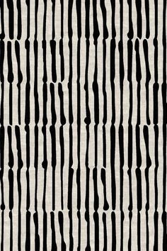 an abstract black and white pattern with vertical lines on the fabric, as well as small dots