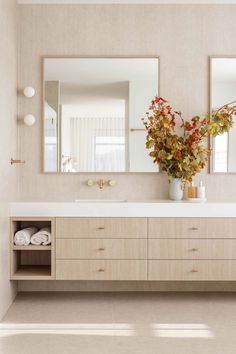 a bathroom with two sinks and mirrors on the wall