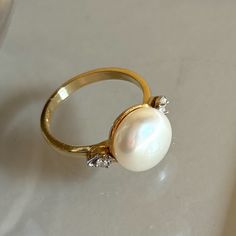 There Are Not Many Gemstones As Synonymous To Pure Elegance Than The Pearl. Termed The “Queen Of Gems,” Pearls Have For Civilizations On End Represented Prestige, Power, And Wealth. Like Its Long History, Pearls Have A Unique Way Of Making Its Wearer Look Elegant, Respectable, And Sophisticated. New, No Tag, Exquisite Ring 10.70mm Pearl In The Center With Diamonds On The Side Stamped Atl 14k Classic White Pearl Ring With Diamond Accents, Timeless Pearl Ring With Diamond Accents For Anniversary, White 14k Gold Jewelry With Round Stone, Timeless Anniversary Pearl Ring With Diamond Accents, Formal White 14k Gold Pearl Ring, Classic Gemstone Rings In Diamond White, Classic Diamond White Gemstone Rings, Timeless Diamond-white Pearl Ring With Diamond Accents, Timeless White Pearl Ring In 14k Gold