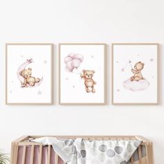 three framed pictures hang on the wall above a crib in a baby's room