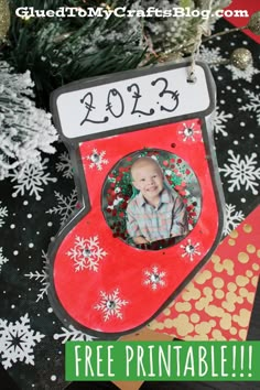 a christmas stocking ornament hanging from a tree with snowflakes on it