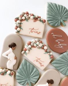 decorated cookies are arranged on a white surface