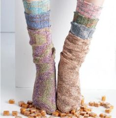 a woman's legs with socks and candy cubes on the ground next to them