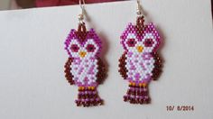 a pair of pink and brown beaded earrings with an owl on it's ear