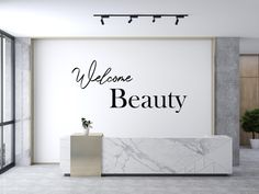 a marble reception table in front of a wall with the words'welcome beauty '