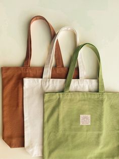 three different colored bags sitting next to each other