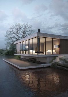 a house on the water with its windows open