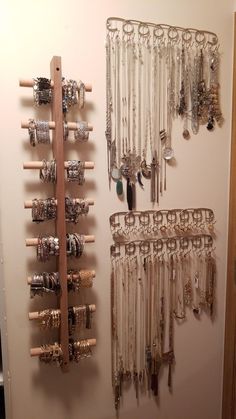 a wall mounted jewelry rack with lots of bracelets hanging from it's sides