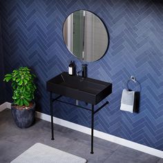 a bathroom sink with a mirror above it and a towel hanging on the wall next to it