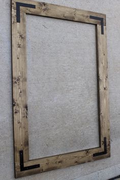 an empty wooden frame hanging on the wall