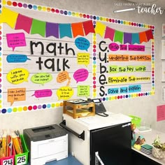 a classroom wall with colorful bulletins and writing on the back walls, along with other school supplies