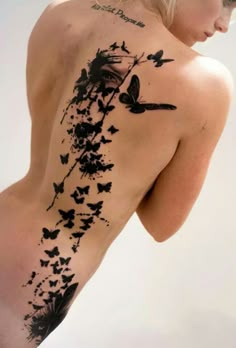 the back of a woman's body with butterflies on it