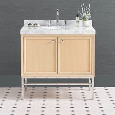 a bathroom vanity with two sinks and a tiled floor