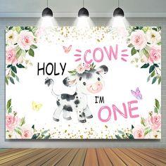 a cow with flowers and butterflies on it's head is standing in front of a wall